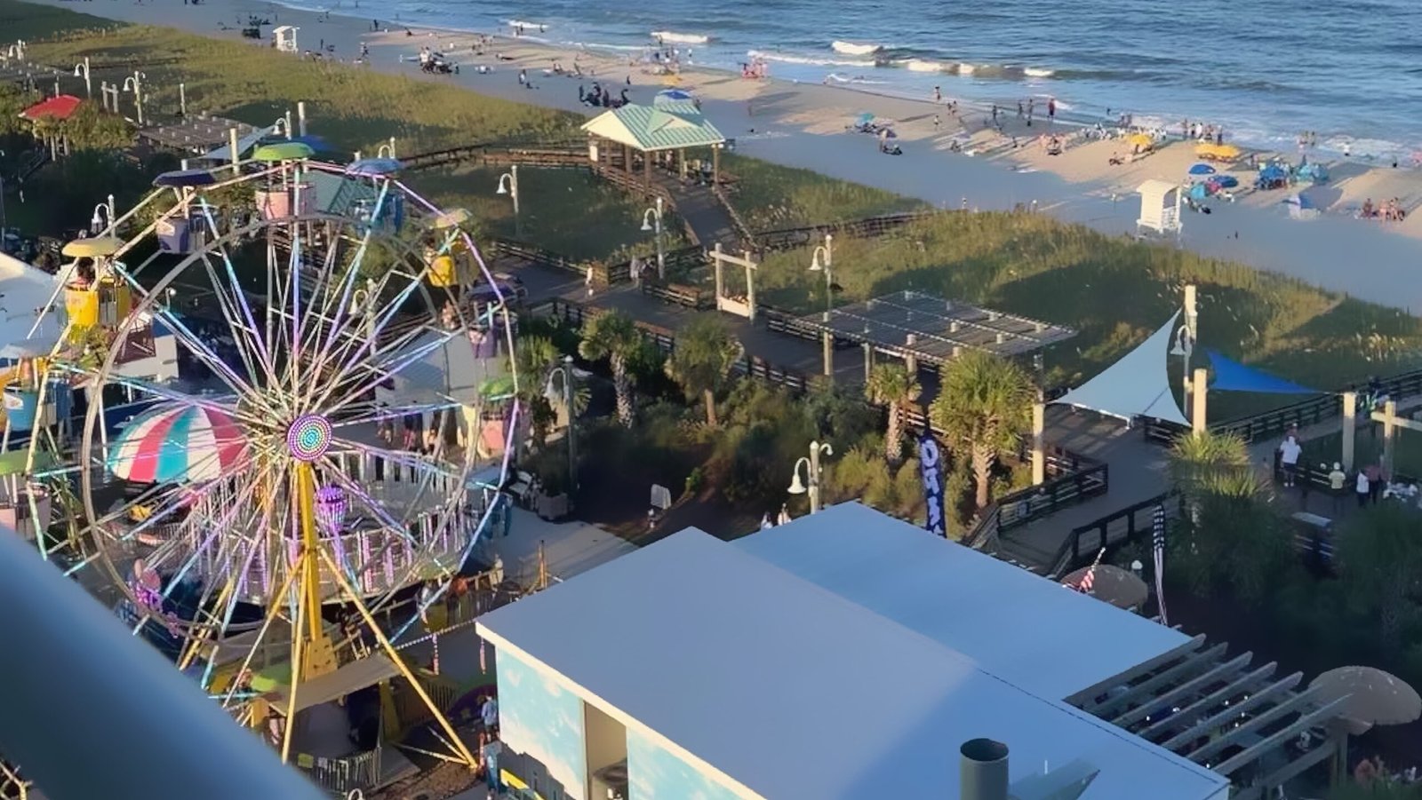 Over looking the boardwalk area of carolina beach from the aire showing the ferris wheel all the way to the ocean