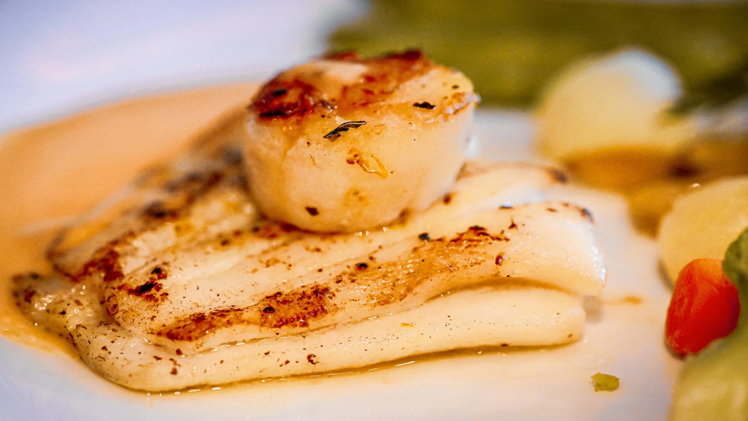 restaurant seafood dish with salmon and scallops