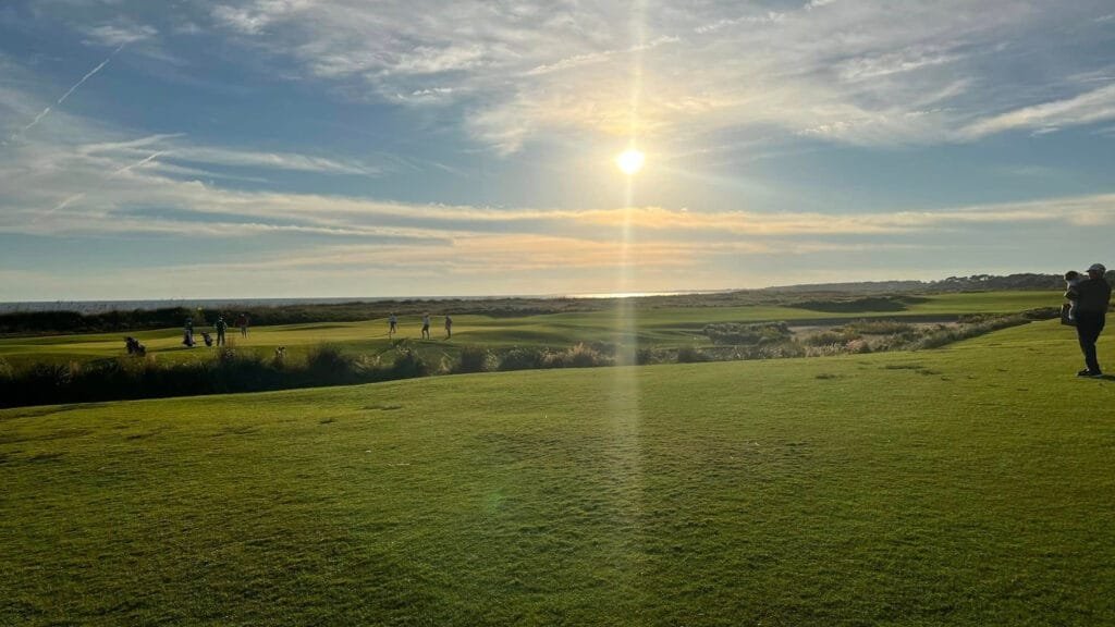 view of kiawah island golfers on a course just after sunrise