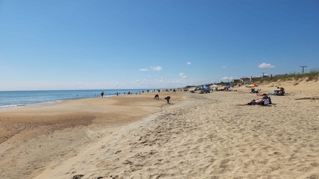 People relaxing in the sun on kitty hawk beach in North carolina