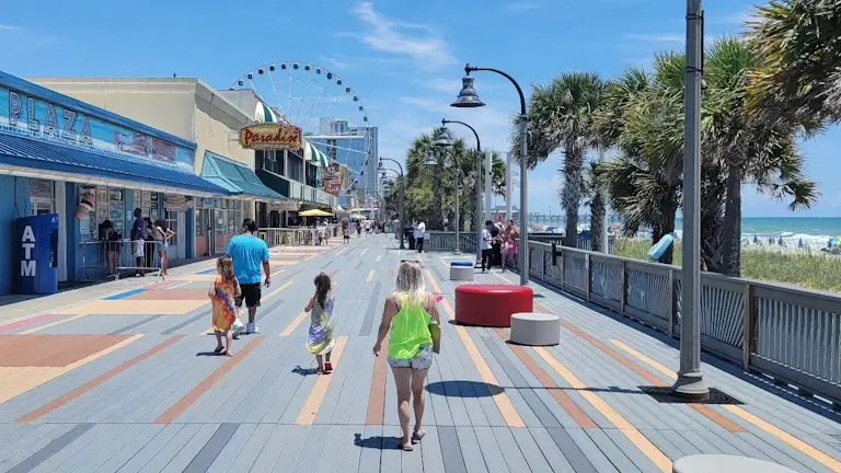 people walking along the boardwalk of myrtle beach south carolina
