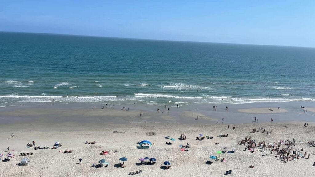 a view of beach goers enjoying the sunshine and waves at north myrtle beach sc