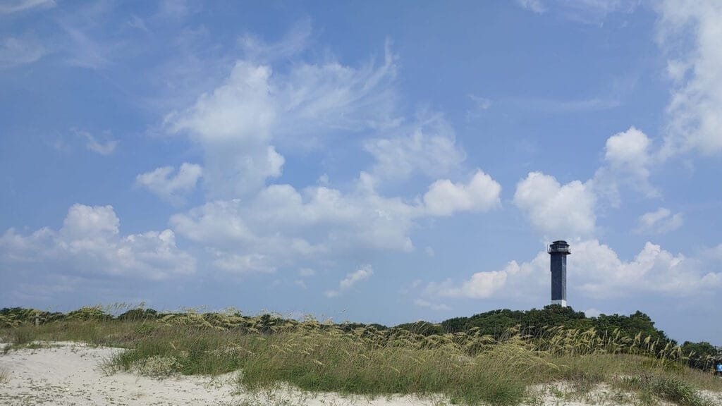 a view from the beach of the lighthouse on sullivans island