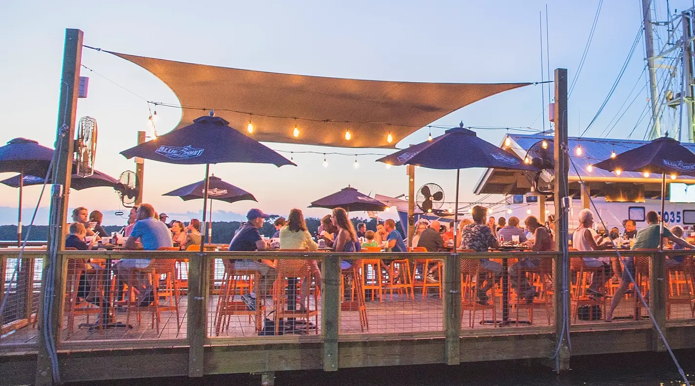 Dockside dining at dusk with shrimp boats at Hudson's Seafood House on the Docks, Hilton Head
