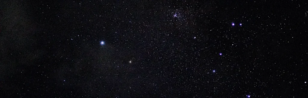Close-up star field showing a bright star cluster and scattered constellations