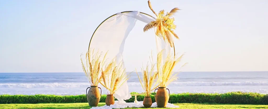Boho wedding arch with pampas grass overlooking the ocean