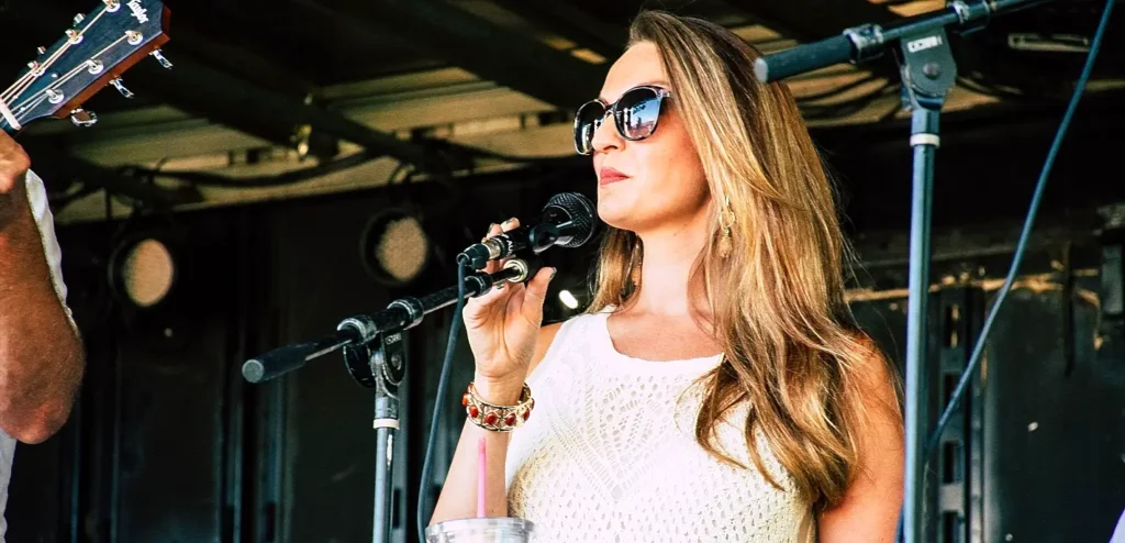 Vocalist performing live music on stage at an Outer Banks festival in Manteo