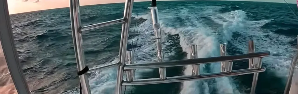 View from a sportfishing boat's rod holders looking back at the churning wake
