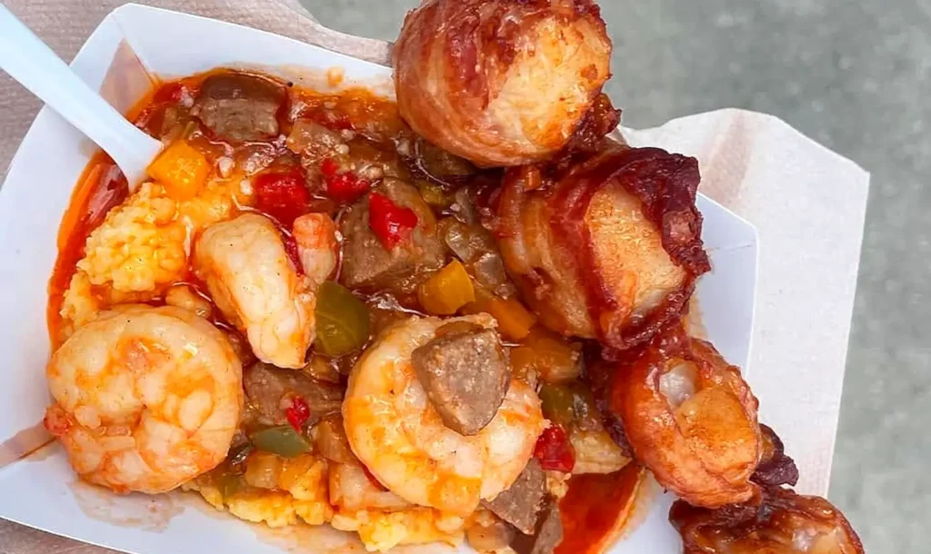 Close-up of shrimp and grits with bacon-wrapped bites, a NC Seafood Festival plate