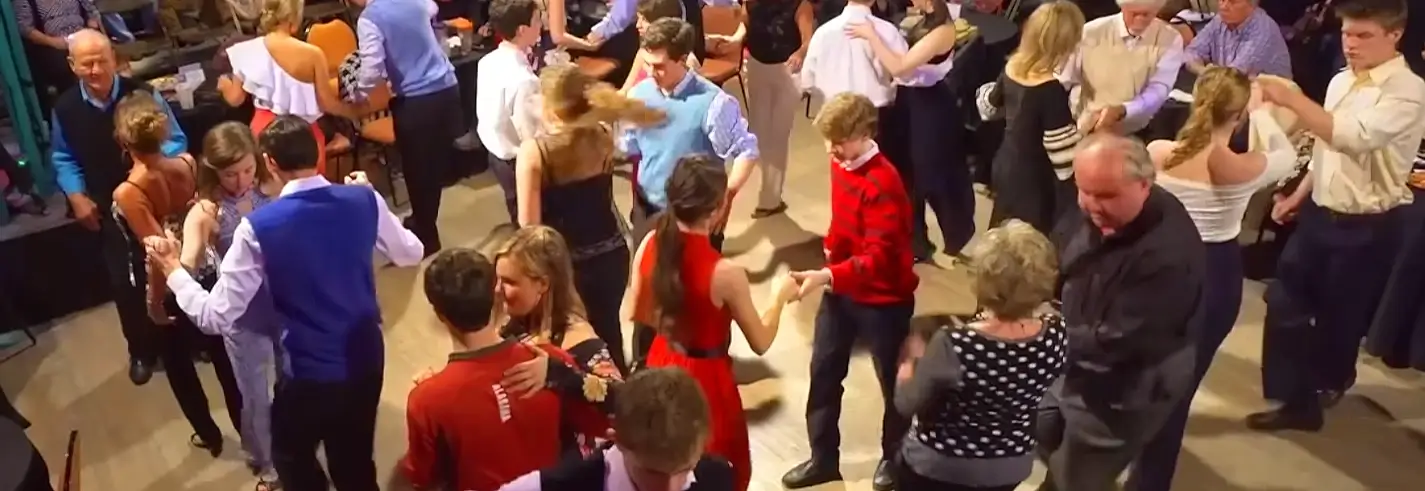 Overhead view of couples dancing together at a lively indoor shag social