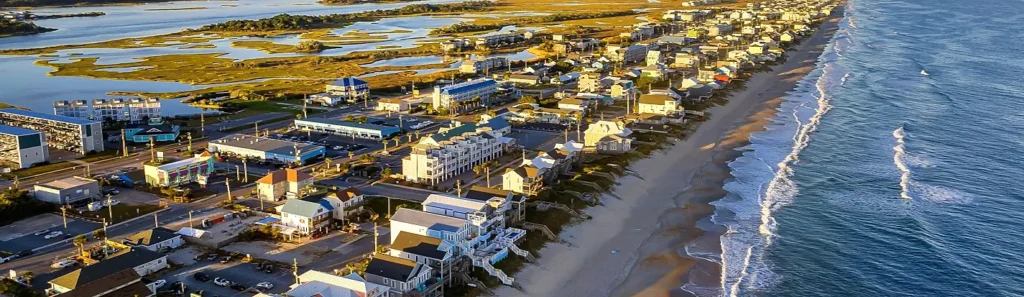 Aerial view of Surf City, NC homes along the beach and marsh at sunset
