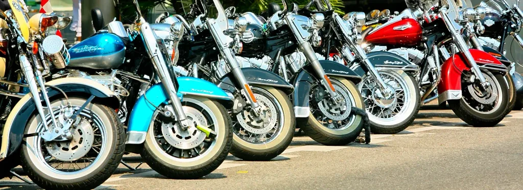 Row of colorful Harley-Davidson Road King motorcycles parked front-to-back at Myrtle Beach Bike Week