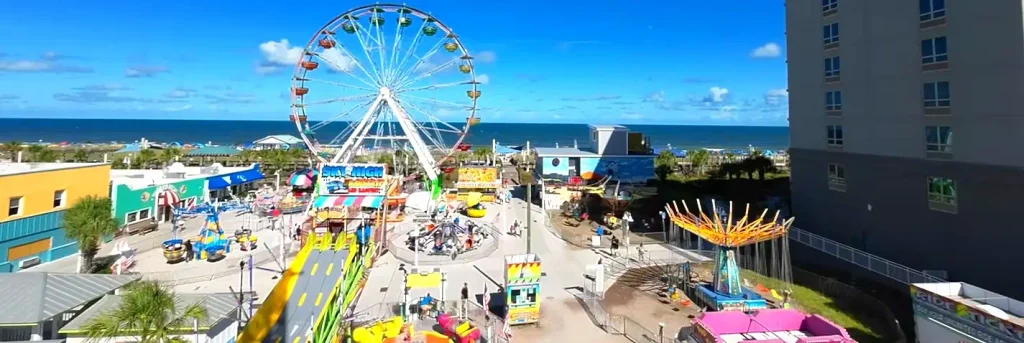 Aerial view of the Carolina Beach boardwalk Ferris wheel and rides along the oceanfront