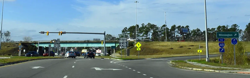 Traffic intersection with road signs to Wilmington and I-40 in coastal North Carolina