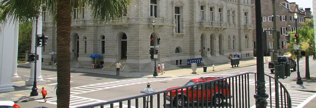 Historic Charleston street corner with a red pickup truck at a crosswalk