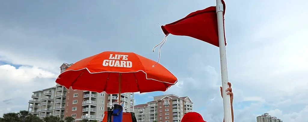 Lifeguard umbrella and red flag flying on a Carolina beach